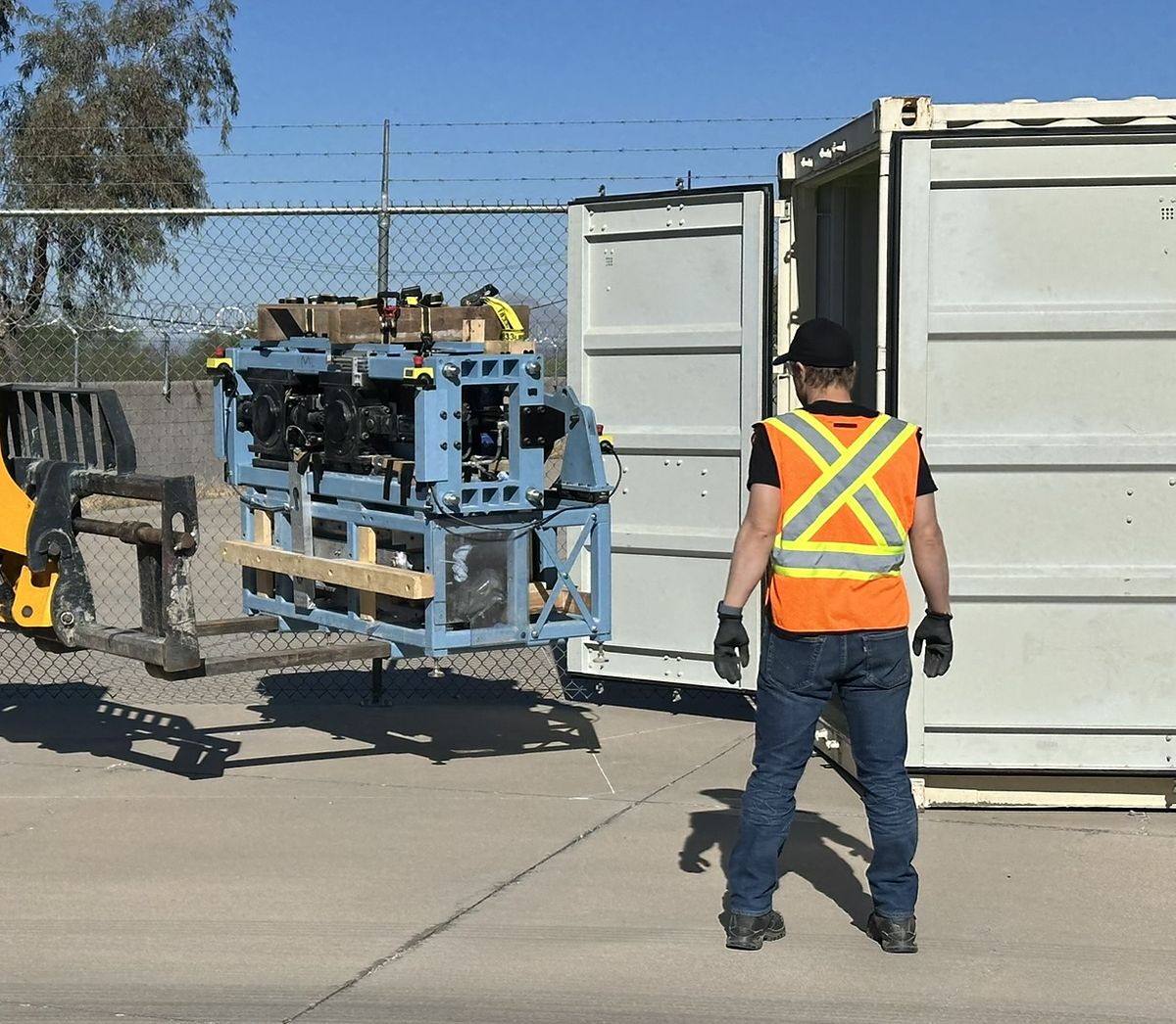 A Minpraxis Tester being loaded into a shipping container