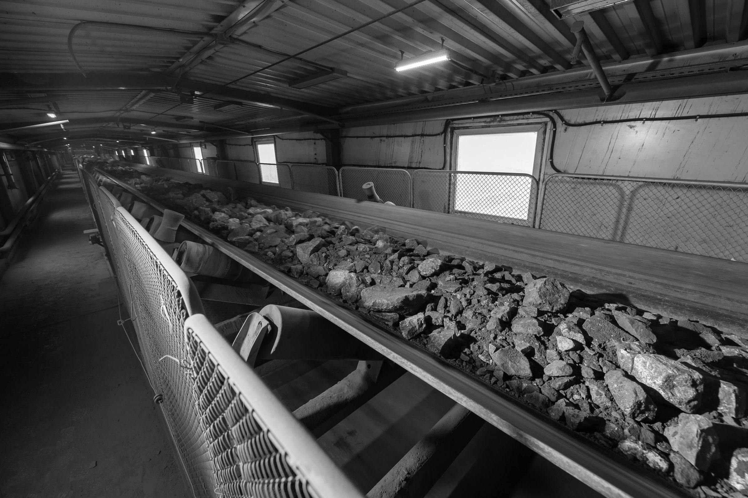 Ore on a conveyor belt, black and white